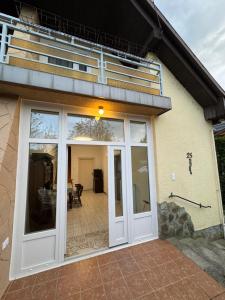 a sliding glass door of a house with a patio at Anna Ház in Balatonkeresztúr