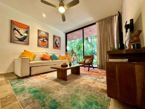 a living room with a couch and a table at Caribbean soul in Tulum