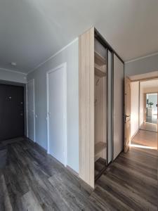 an empty room with a closet with a mirror at Friendly Apartment in Valmiera