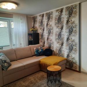 a living room with a couch and a wall at Lennuki Apartement in Rakvere