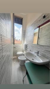 a bathroom with two toilets and a sink at New flat naviglio in Milan