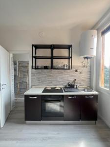 a kitchen with a sink and a stove top oven at New flat naviglio in Milan