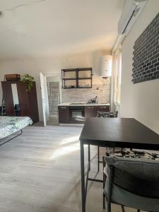 a living room with a table and a kitchen at New flat naviglio in Milan