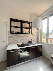 a kitchen with a stove and a sink in it at New flat naviglio in Milan +2 photos