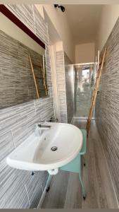 a bathroom with a white sink and a mirror at New flat naviglio in Milan