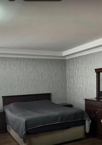 a bedroom with a bed in a room at Eka's house in Goristsikhe in Itʼkhvisi