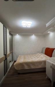 a bedroom with a bed and a light on the ceiling at Eka's house in Goristsikhe in Itʼkhvisi