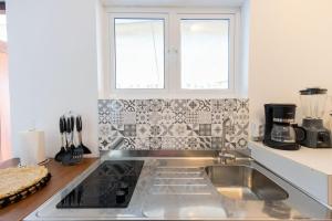 a kitchen with a stainless steel sink and a window at Tango Apartment - Mi Cuna Stays Collection in Jan Thiel