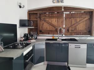 a kitchen with a sink and a stove top oven at Paradise House in Saint-François