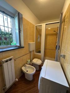 a small bathroom with a toilet and a sink at Bilocale Voltri Mare 4 posti in Genova +7 photos