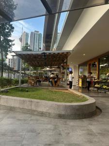 a lobby of a building with a table and benches at The Roberstson family suite with city views in Kuala Lumpur +31 photos