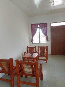 a room with a table and chairs and a window at Villa Rosita in Dauin