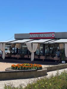 an asia substitute store with flowers in front of it at Квартира на Иссык-куле в ЦО Радуга in Chon-Sary-Oy