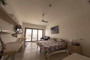 a living room with a bed and a couch in a room at Olivier Residence in Nicosia