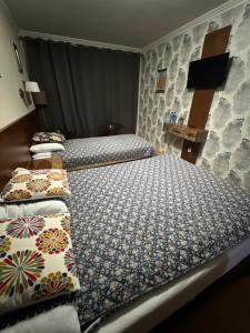 a bedroom with two beds with pillows on them at Noclegi Siwy Las in Oleszyce