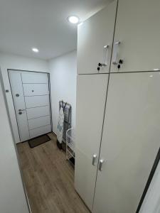 a room with a white closet and a door at Studio 032 in Prčanj