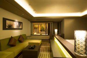 a living room with a couch and a bed at Hotel Keihan Kyoto Grande in Kyoto
