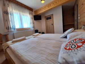 Postel nebo postele na pokoji v ubytování Pokoje Gościnne Wierzbówka przy Termach