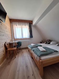 Postel nebo postele na pokoji v ubytování Pokoje Gościnne Wierzbówka przy Termach