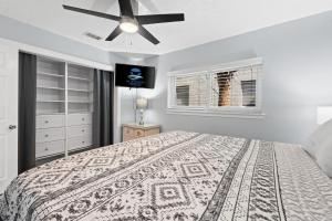 a bedroom with a bed and a ceiling fan at New! Beach Walk 6! Dog Friendly, Free Activities Included! in Fort Walton Beach