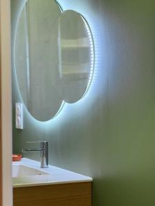a bathroom with a sink and a mirror on the wall at Casa Escuela in Plougastel-Daoulas +9 photos