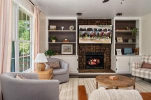 a living room with a fireplace and a tv at Trailside Country Haven in Bagdad +56 photos