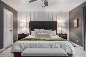 a bedroom with a large bed with two lamps at Trailside Country Haven in Bagdad