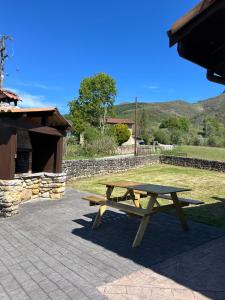 a wooden picnic table sitting on a patio at Casa Rural Laurenea in Alzate