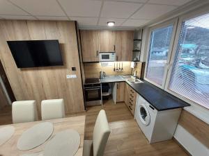 a kitchen with a washer and dryer in a room at Apartmán Discovery in Ulič