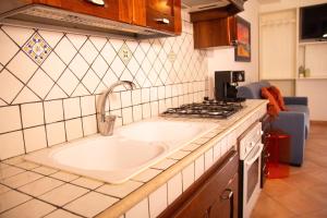 a kitchen with a sink and a stove at Anemos Apartment - Villa Luna in Macari