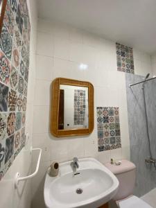a bathroom with a sink and a toilet and a mirror at Mabel in San Javier
