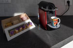 a small microwave and a box of cupcakes and a coffee mug at Sea Reflections Nimborio Beachfront Houses in Animborió +18 photos