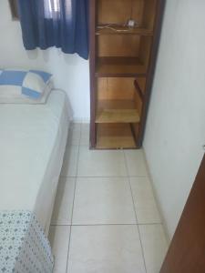 a small room with a bed and a closet at Gust Hause Ilhabela in Ilhabela
