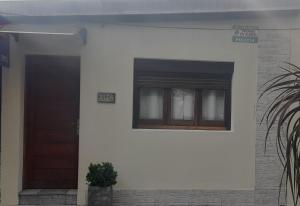 a house with a door and a window at Casa Color in Florida +1 photo