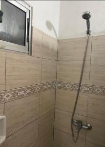 a bathroom with a shower with a tv on the wall at Casa Color in Florida