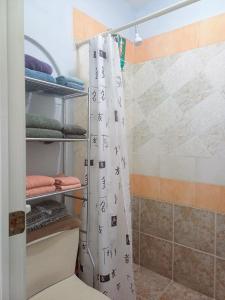 a shower curtain with asian writing on it in a bathroom at Tziimin Nahil Cozumel in Cozumel