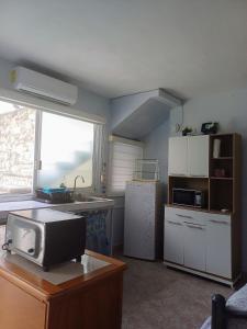 a kitchen with a sink and a refrigerator and a microwave at Tziimin Nahil Cozumel in Cozumel +9 photos