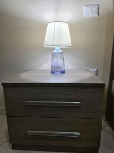 a blue lamp sitting on top of a dresser at Casadaema in Acerra