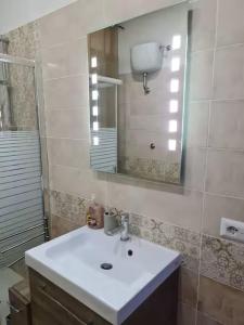 a bathroom with a sink and a mirror at Casadaema in Acerra