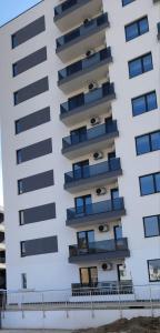 a tall white building with balconies on it at Primavera Pipera Plaza in Voluntari
