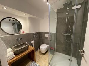 a bathroom with a shower and a toilet and a mirror at Stylishes & neues Premium-Loft in Tönisvorst +5 photos