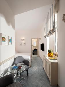 a living room with a bed and a table at Boutique Hotel Casa Mariantonia in Anacapri