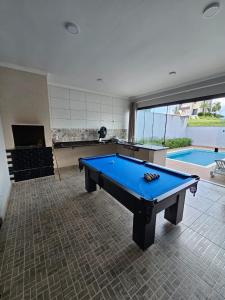 a room with a pool table and a swimming pool at Ninho Verde Holiday Home in Quadra +19 photos