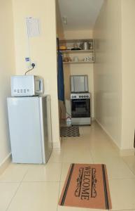 a kitchen with a refrigerator and a sign on the floor at 3 Jays Homes in Narok