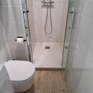 a bathroom with a shower with a toilet and a sink at T2 West CITY Parking Clim Wifi 4pers - ROSSIconciergerie - Linge inclus in La Grande-Motte