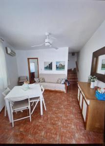 a living room with a couch and a table at Duplex Barbados Aguamarga in Agua Amarga