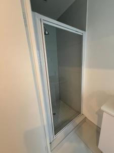 a shower with a glass door in a bathroom at Carpe Diem in Langebaan