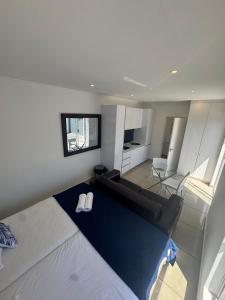 a bedroom with a bed and a living room at Carpe Diem in Langebaan +6 photos