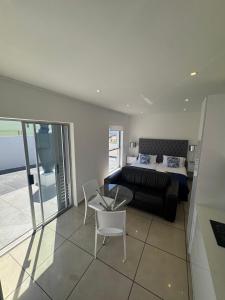 a bedroom with a bed and a glass table at Carpe Diem in Langebaan