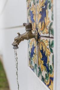 a brass water faucet attached to a wall at Hotel Mignon Meublè in Sorrento
